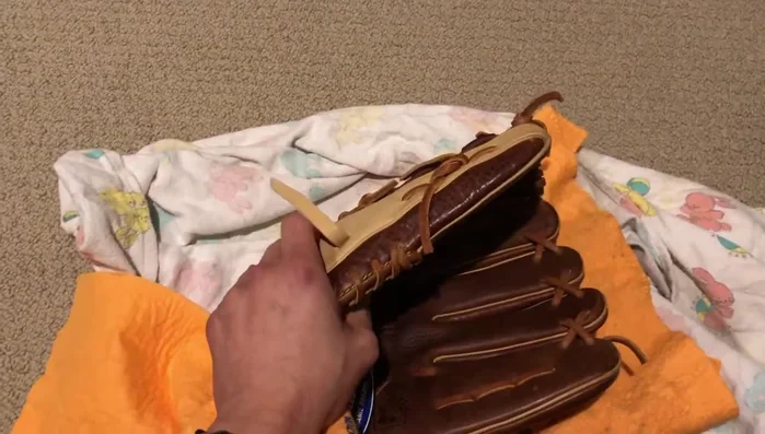 Repeat steps 3-5 for several days, changing towels frequently, until the glove is nearly dry.