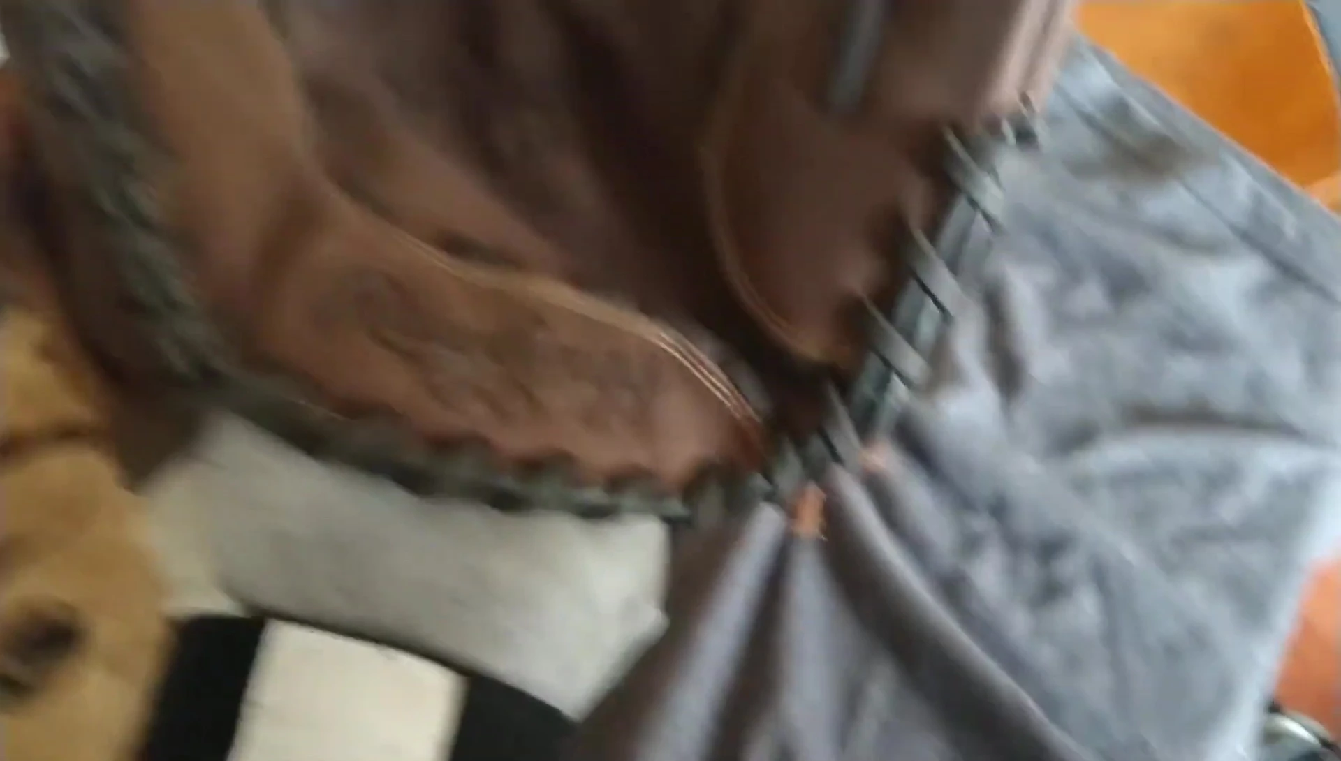 The speaker pointing to the hardest part of the glove to break in