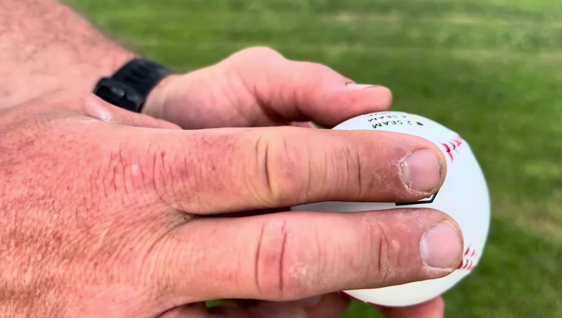 Close-up showing finger placement for a two-seam fastball.