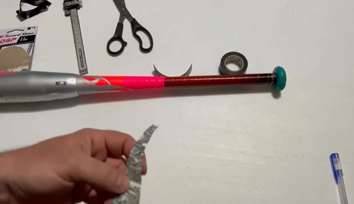 For a right-handed batter, align the shorter pre-cut angle of the new grip with the knob of the bat.