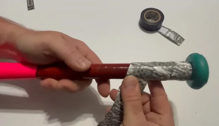 Continue wrapping, peeling back more backing paper as you go, maintaining consistent overlap.