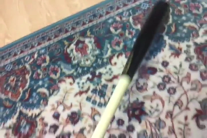 Close-up of the speaker's hands on the bat handle, demonstrating the grip.