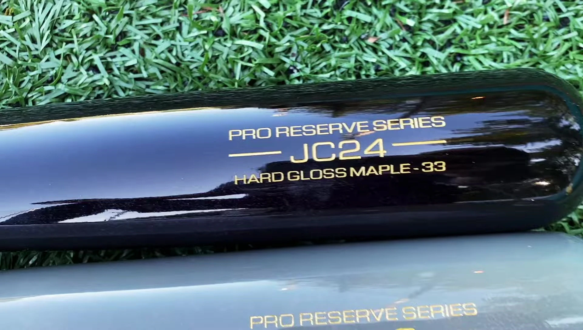 A detailed shot of the JC24 bat, highlighting its smaller barrel and later taper.