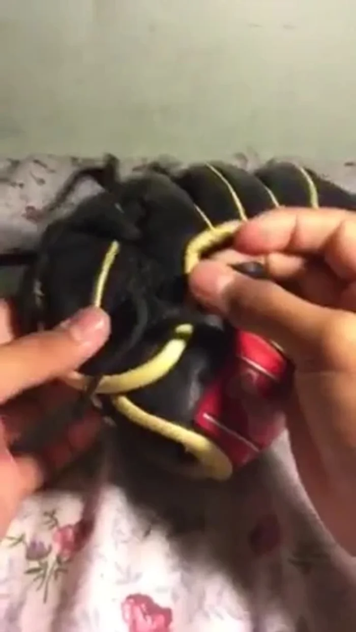 Continue creating the 'X' pattern, skipping a hole each time. This might require using your hands or tweezers/pliers to maneuver the lace through the tight spaces.