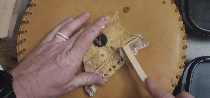 Gently scrub the labels and the glove's surface, paying attention to crevices and areas where dirt accumulates.