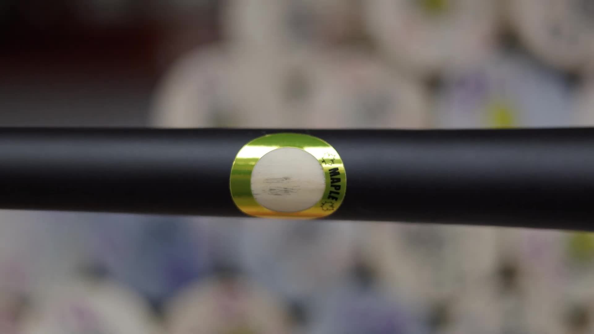 Close-up shot highlighting the difference in wood grain between maple and birch bats.