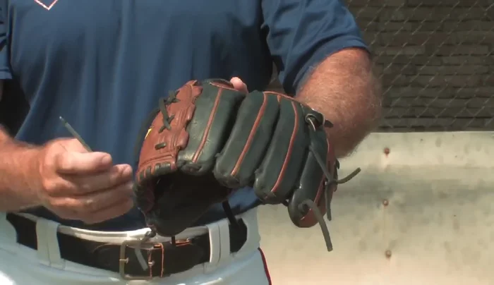 Take the glove apart piece by piece, noting how each section is laced.