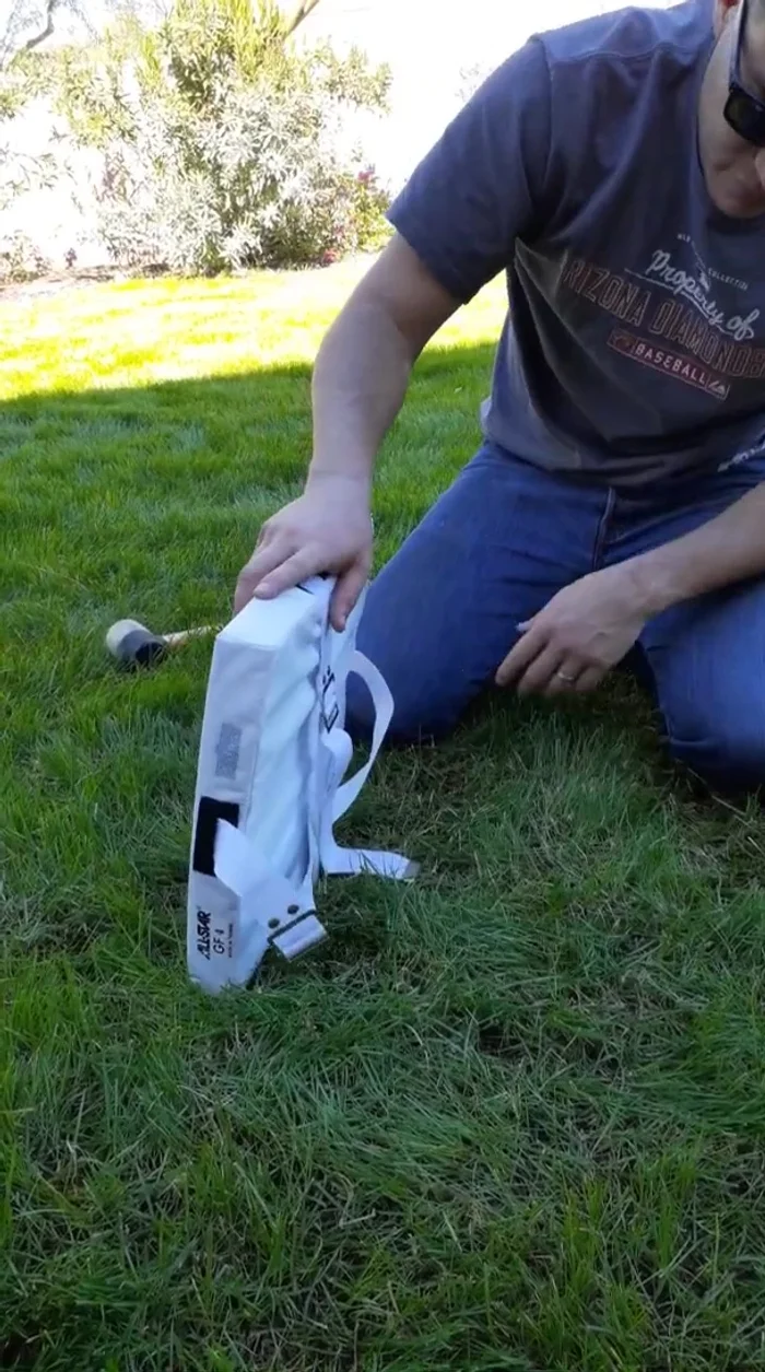 Drive the anchors down until they are flush with the ground. Tighten the straps.