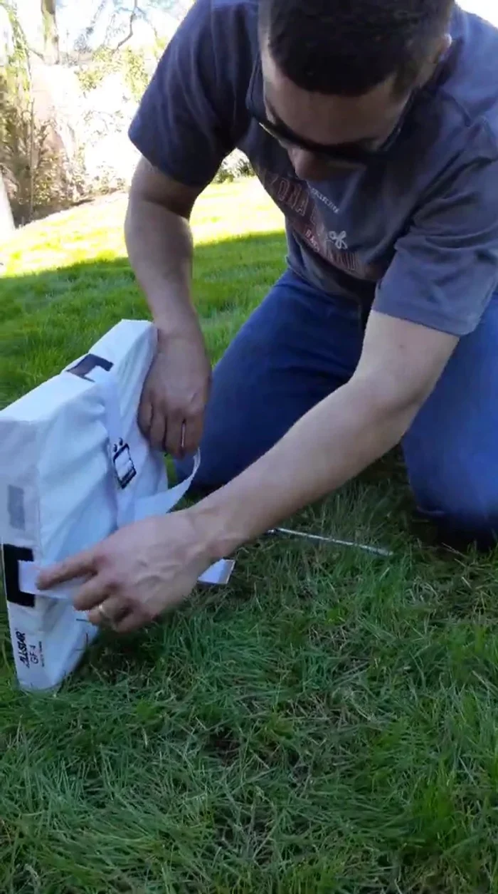 Drive the anchors down until they are flush with the ground. Tighten the straps.