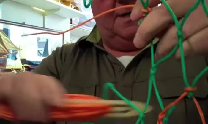 Continue picking up meshes to the right, securing each one with a hitch around the back.