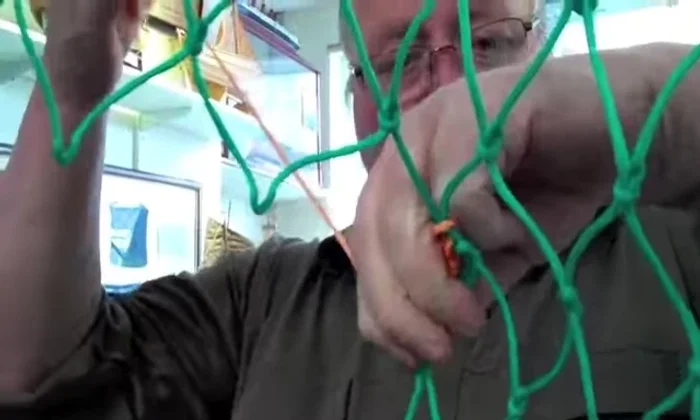 Continue picking up meshes to the right, securing each one with a hitch around the back.