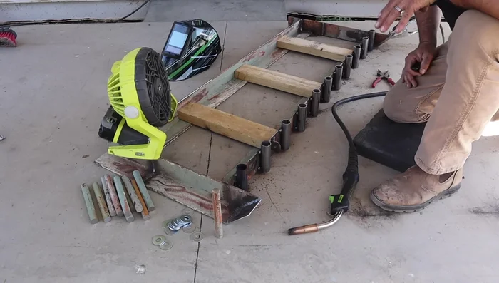 Weld the rake mechanism components securely, using a staggered welding technique to prevent warping.
