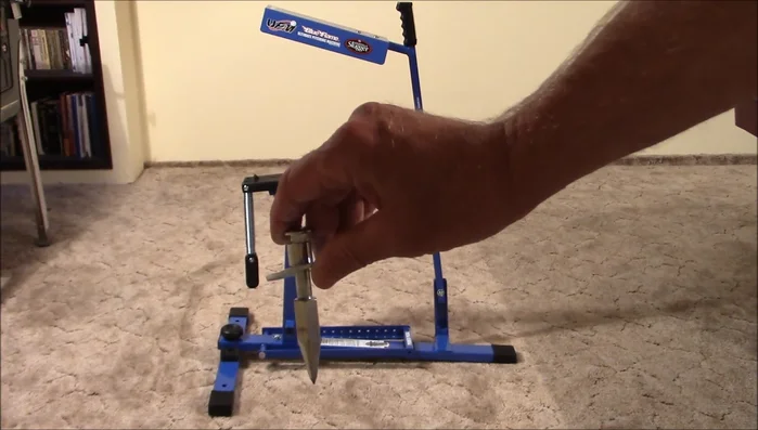 Attach two securing spikes to the front leg assembly (though these are considered inadequate; use camping stakes instead).