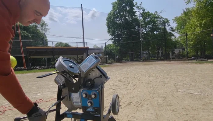 Feed softballs into the feeder, making adjustments until satisfied with the location.