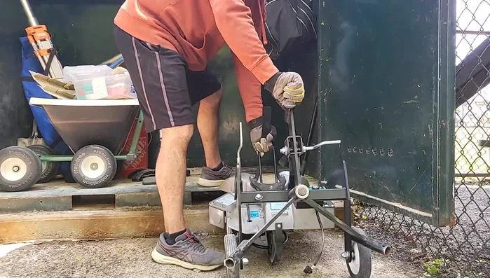 Attach the long handle attachment to the top socket and roll the machine to the desired location.