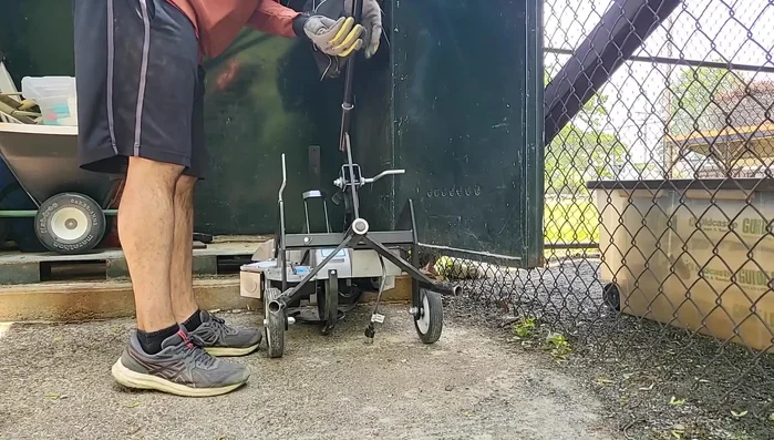 Attach the long handle attachment to the top socket and roll the machine to the desired location.