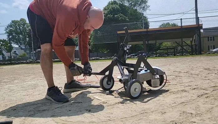 Remove the long handle and attach the short attachments. Pivot the machine down onto its three legs.