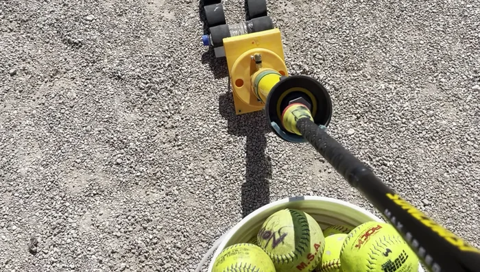 Engage the Machine: Slowly and steadily push the bat handle into the designated area on the machine. You'll hear a click when it's properly engaged.