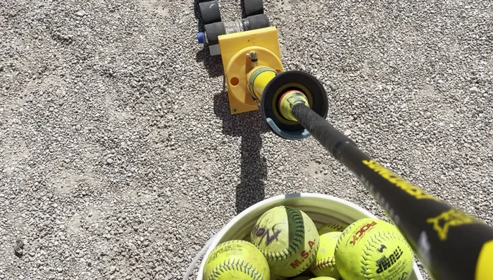 Engage the Machine: Slowly and steadily push the bat handle into the designated area on the machine. You'll hear a click when it's properly engaged.