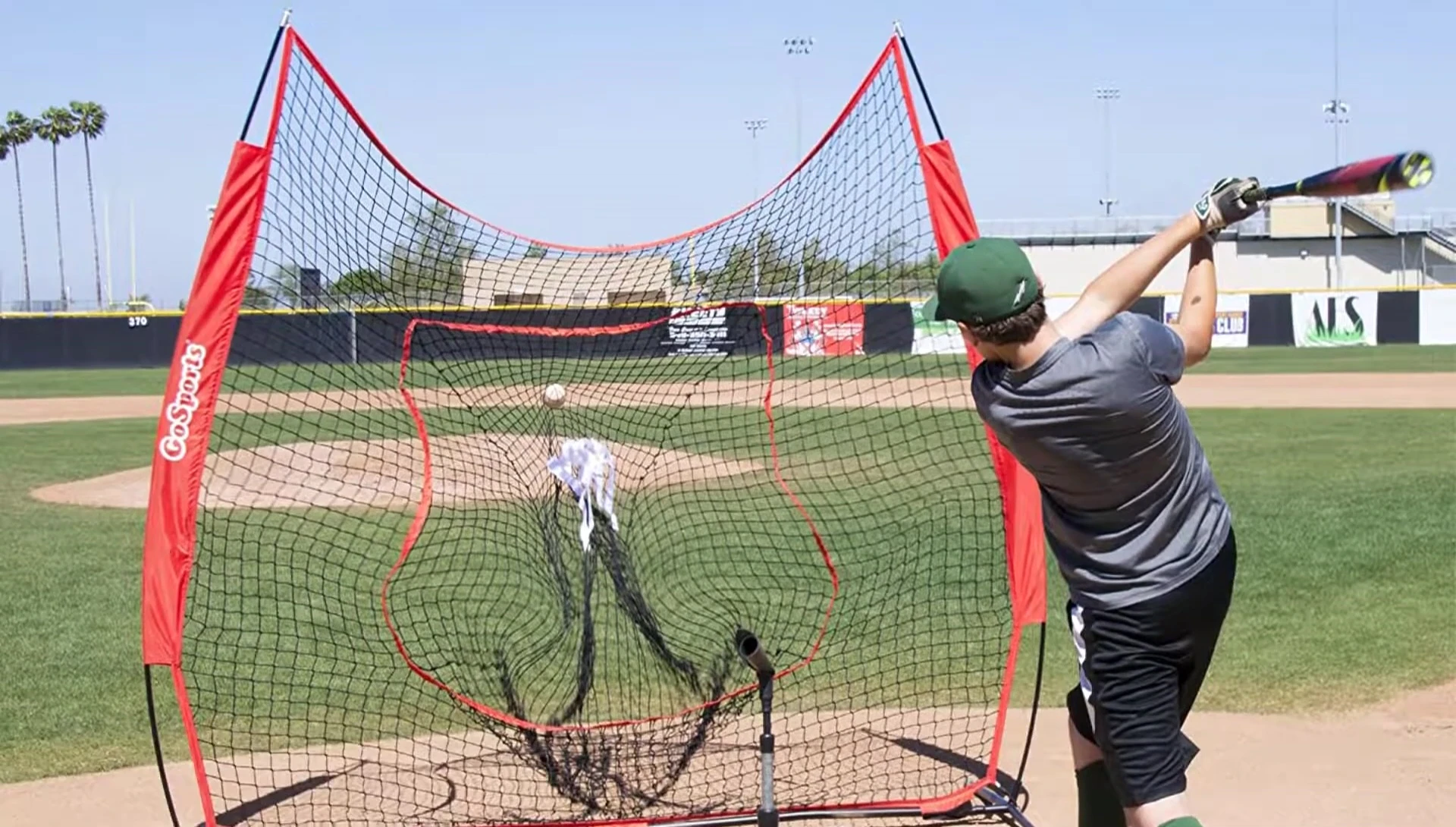 A person easily setting up a softball hitting net.