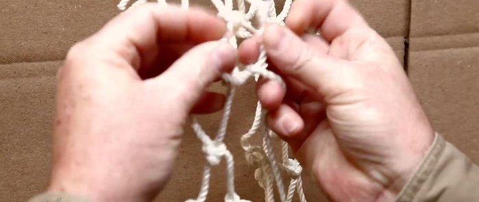 Tie a square knot: Secure the twine to the existing net strings using a square knot. Ensure the knot doesn't fall between existing knots.