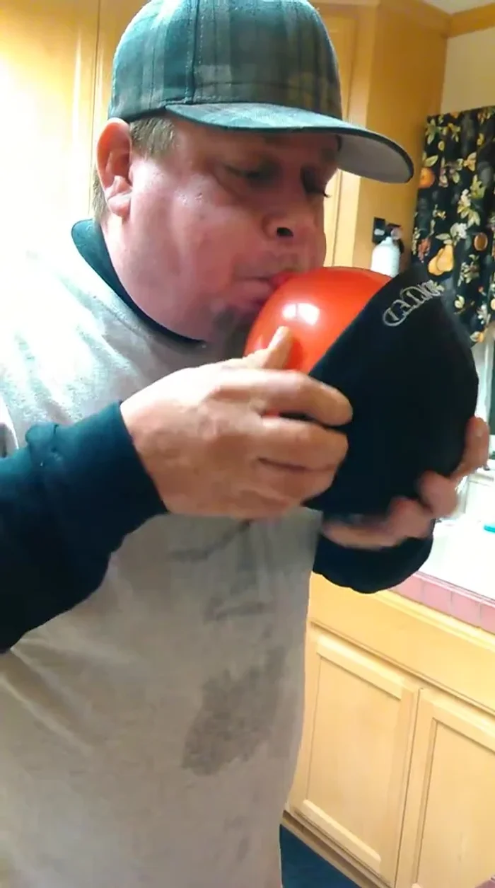 Position the hat around the inflated balloon, ensuring it's nicely rounded and wrinkle-free.