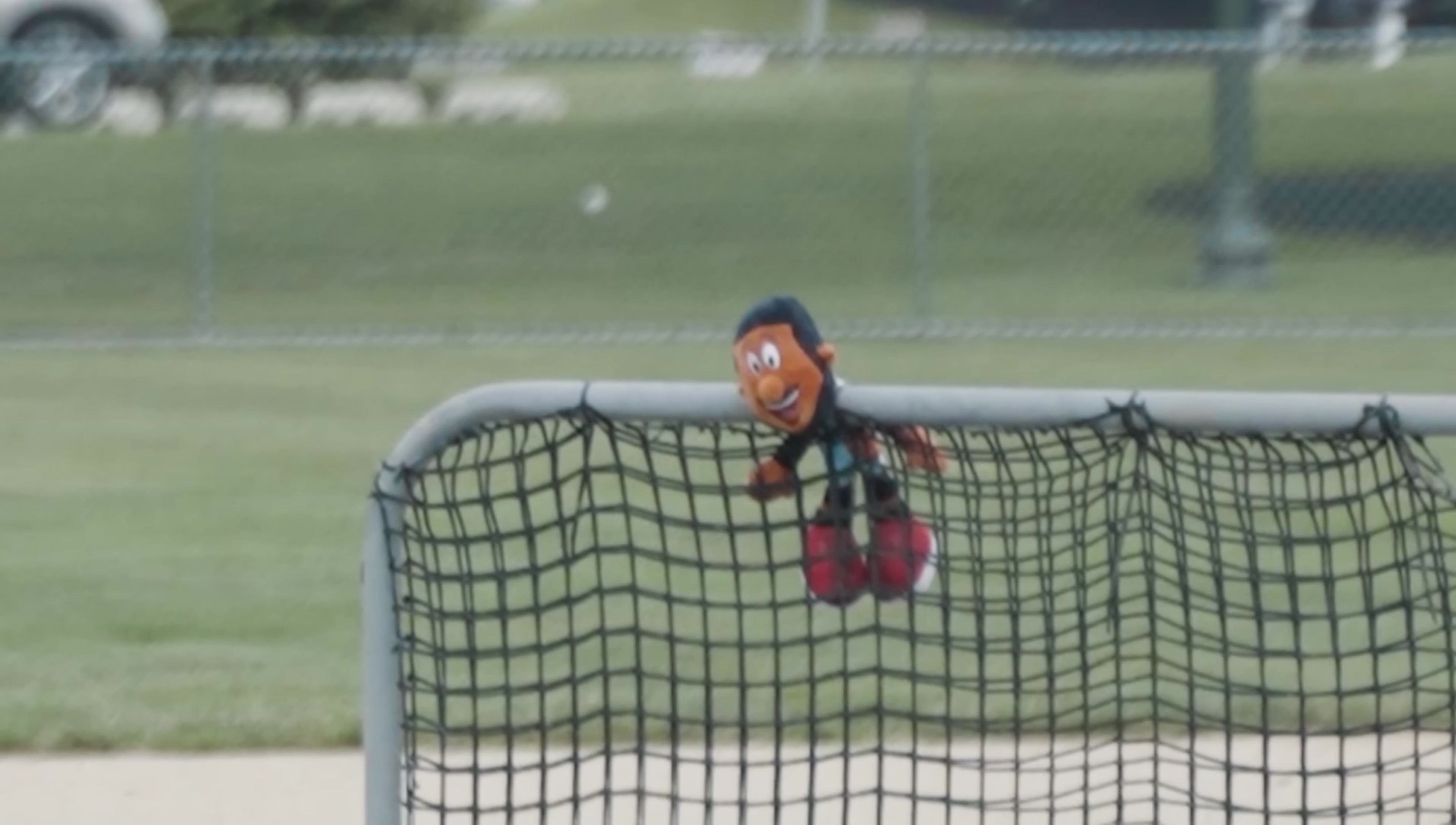 One of the team members hitting a baseball with the Rawlings bat.