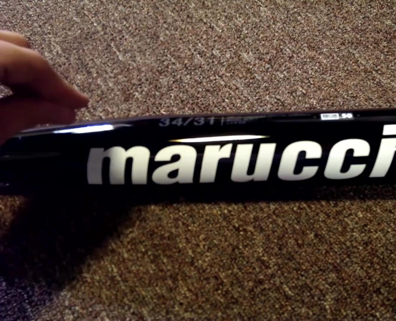 The bat's high-gloss black finish is visible.