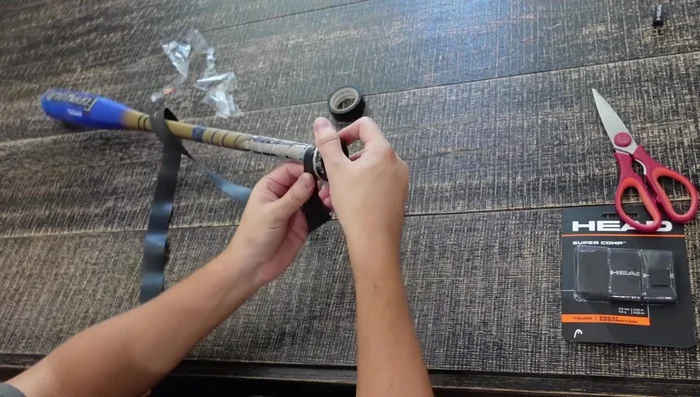 Maintain tension and overlap while wrapping. Keep the tension consistent as you rotate the bat.