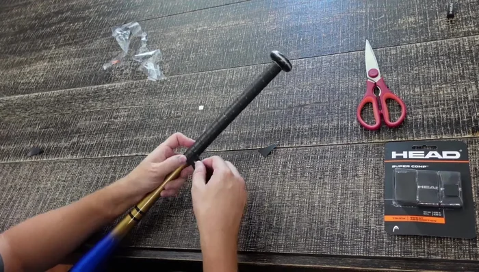 Secure with tape. Once the grip is fully wrapped, use tape to secure the end, overlapping the tape for extra hold.