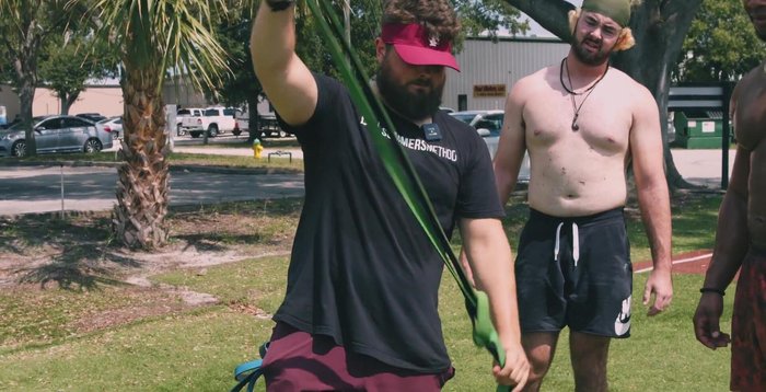 Banded ABCs: Anchor the band as in exercise 6. Perform a pal-off press, then trace the alphabet in the air with large movements.