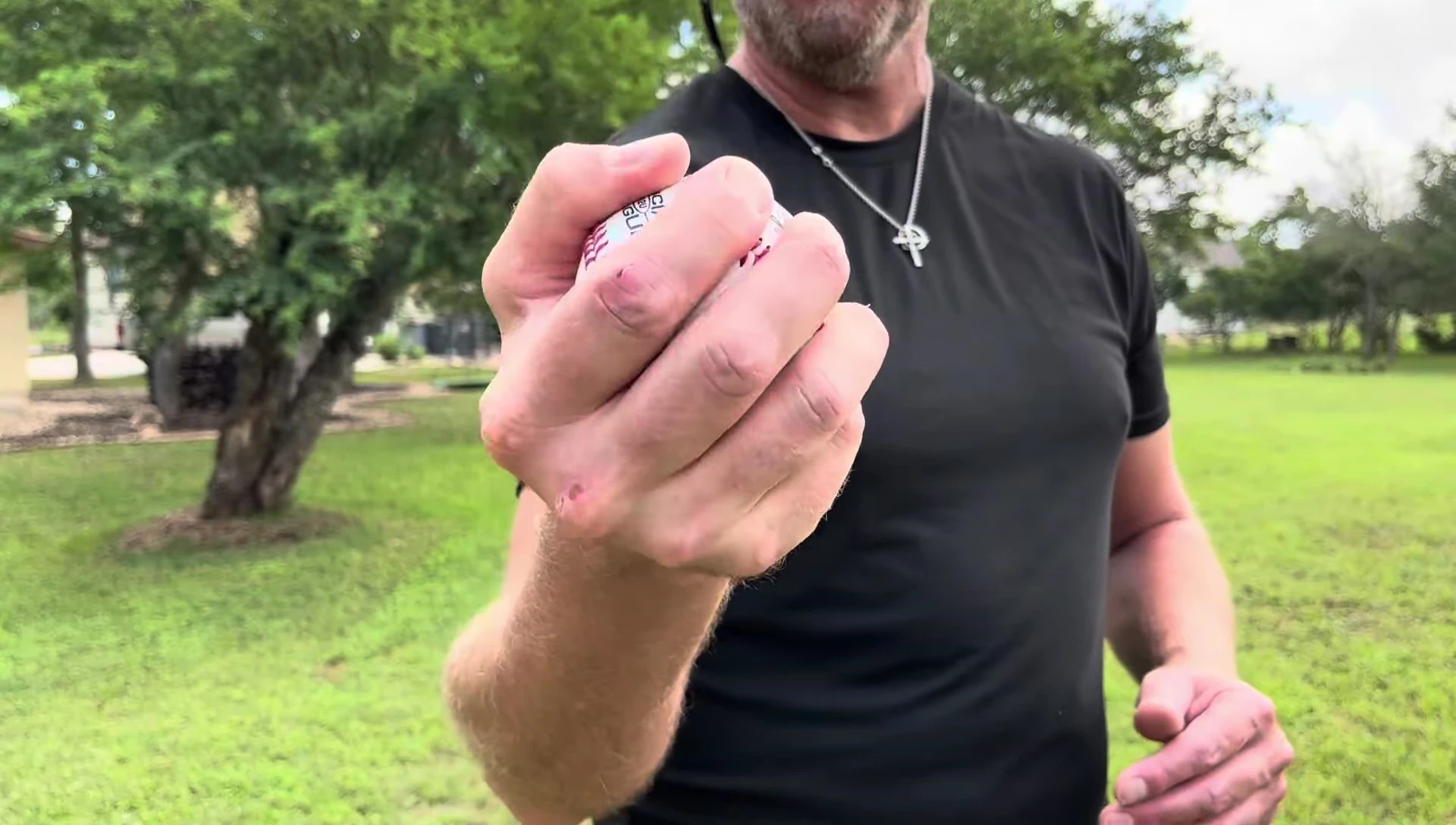 Hand holding the baseball showcasing grip