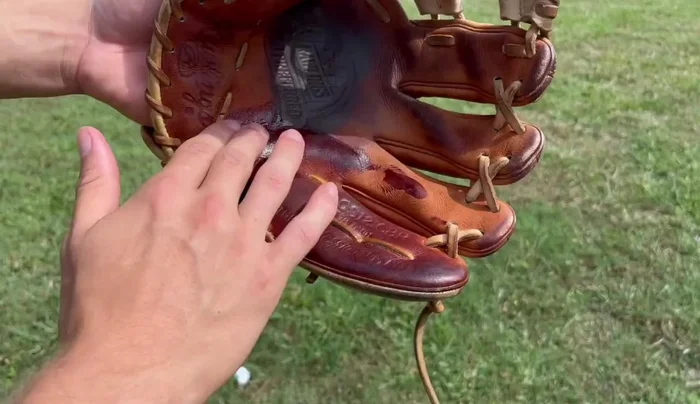 Condition the wrist and exterior. Continue applying conditioner evenly across the wrist and exterior of the glove.