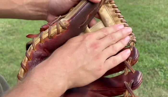 Condition the wrist and exterior. Continue applying conditioner evenly across the wrist and exterior of the glove.