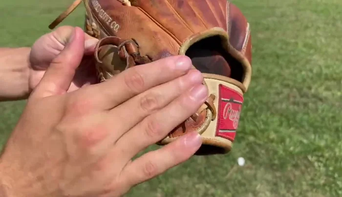 Condition the wrist and exterior. Continue applying conditioner evenly across the wrist and exterior of the glove.