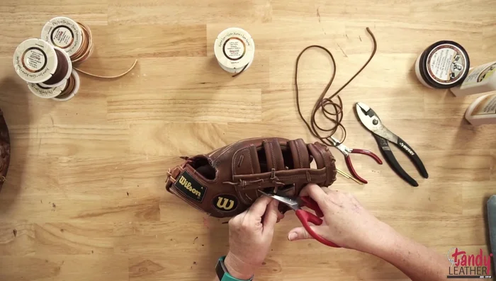 Take apart the glove section by section (e.g., the web first), taking photos as you go to aid in reassembly.