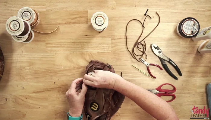 Take apart the glove section by section (e.g., the web first), taking photos as you go to aid in reassembly.