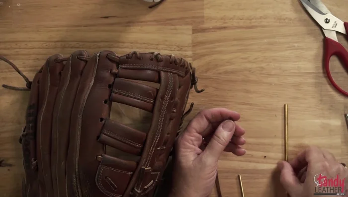 Lace the glove using the chosen lace (Pro Allen or Tandy's Kodiak). Use the large perma lock for larger sections and the small one for smaller sections. Secure the laces using the perma locks; tighten firmly.