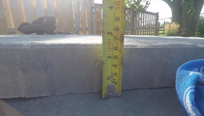 Calculate total excavation depth: base depth + bedding layer + paver height.