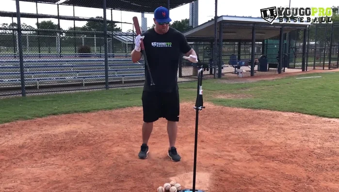 Set up your tee. Adjust its position (height and distance from you) to focus on specific areas like inside or outside pitches.