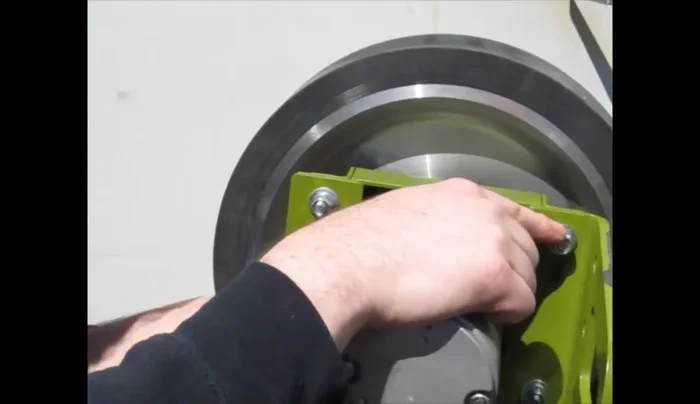 Loosen the remaining two carriage bolts on the top motor mount. Be prepared to hold the motor assembly to prevent it from falling.