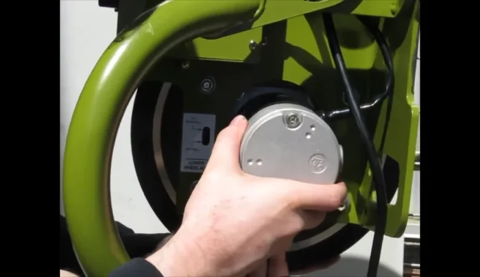 Bring the motor mount all the way to the top of the four slots, hold it in place, and tighten all four nuts.