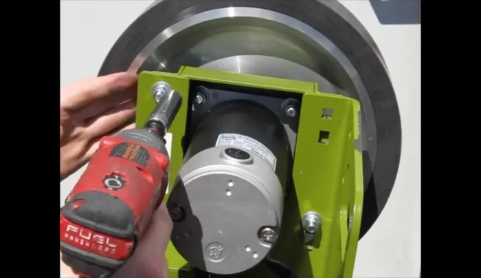 Loosen the remaining two carriage bolts on the top motor mount. Be prepared to hold the motor assembly to prevent it from falling.