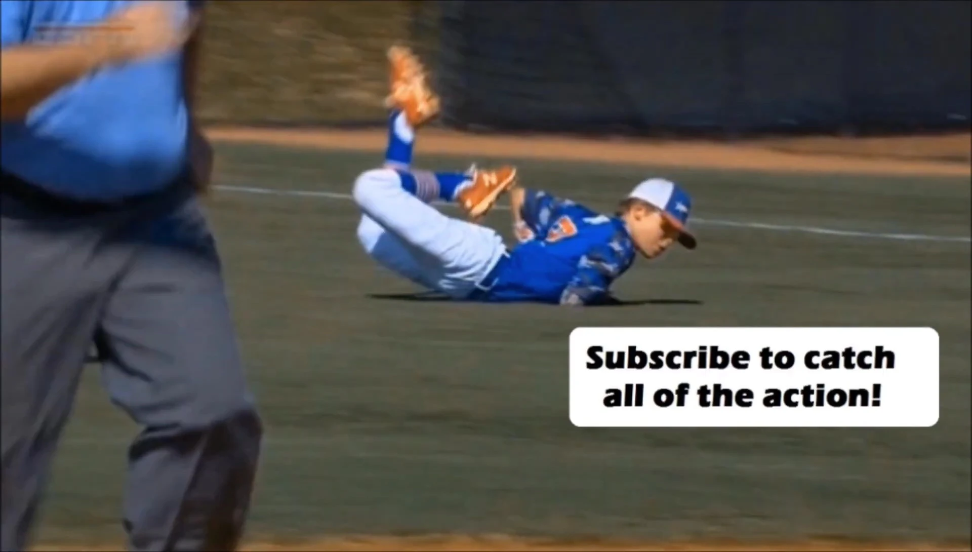 A catcher struggling to carry their equipment
