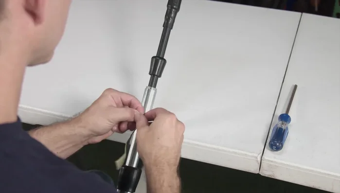 Apply the adhesive strip around the metal pipe and gray ring (halfway up the gray ring, but not covering the top).