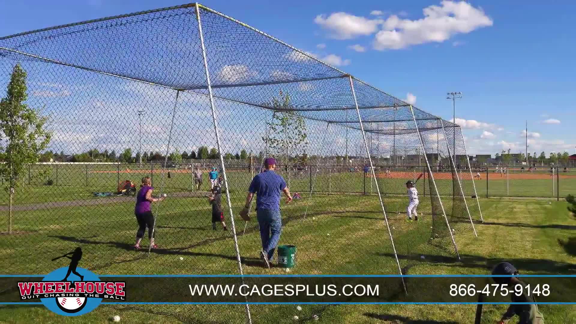 A family happily using the batting cage, emphasizing the safety aspect.