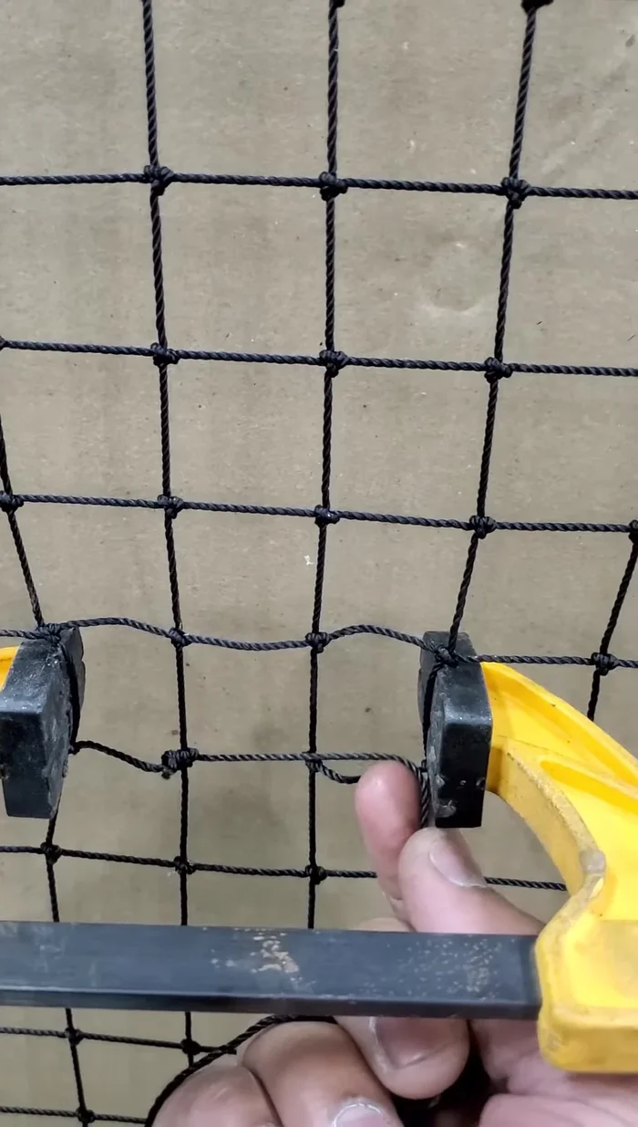 Apply a double fisherman's knot to the other side while the clamps are still loose, ensuring the knot is tight before releasing the clamps.