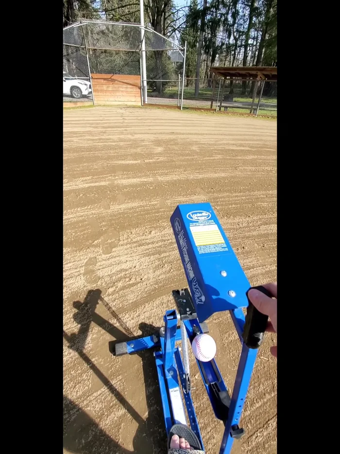 Pull the Trigger: Pull back the trigger to release the pitch.