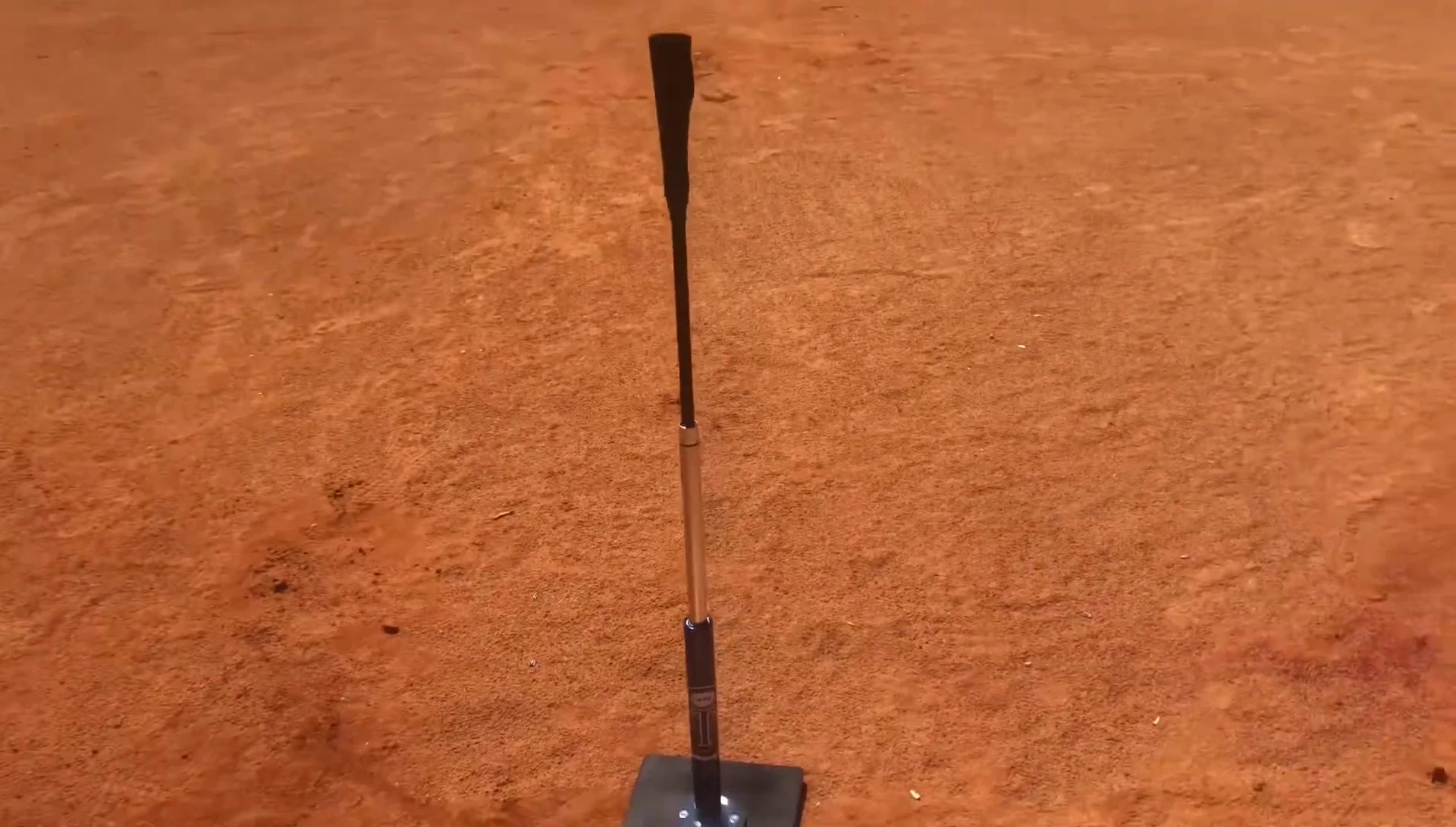 Softball securely placed on the Jugs batting tee.