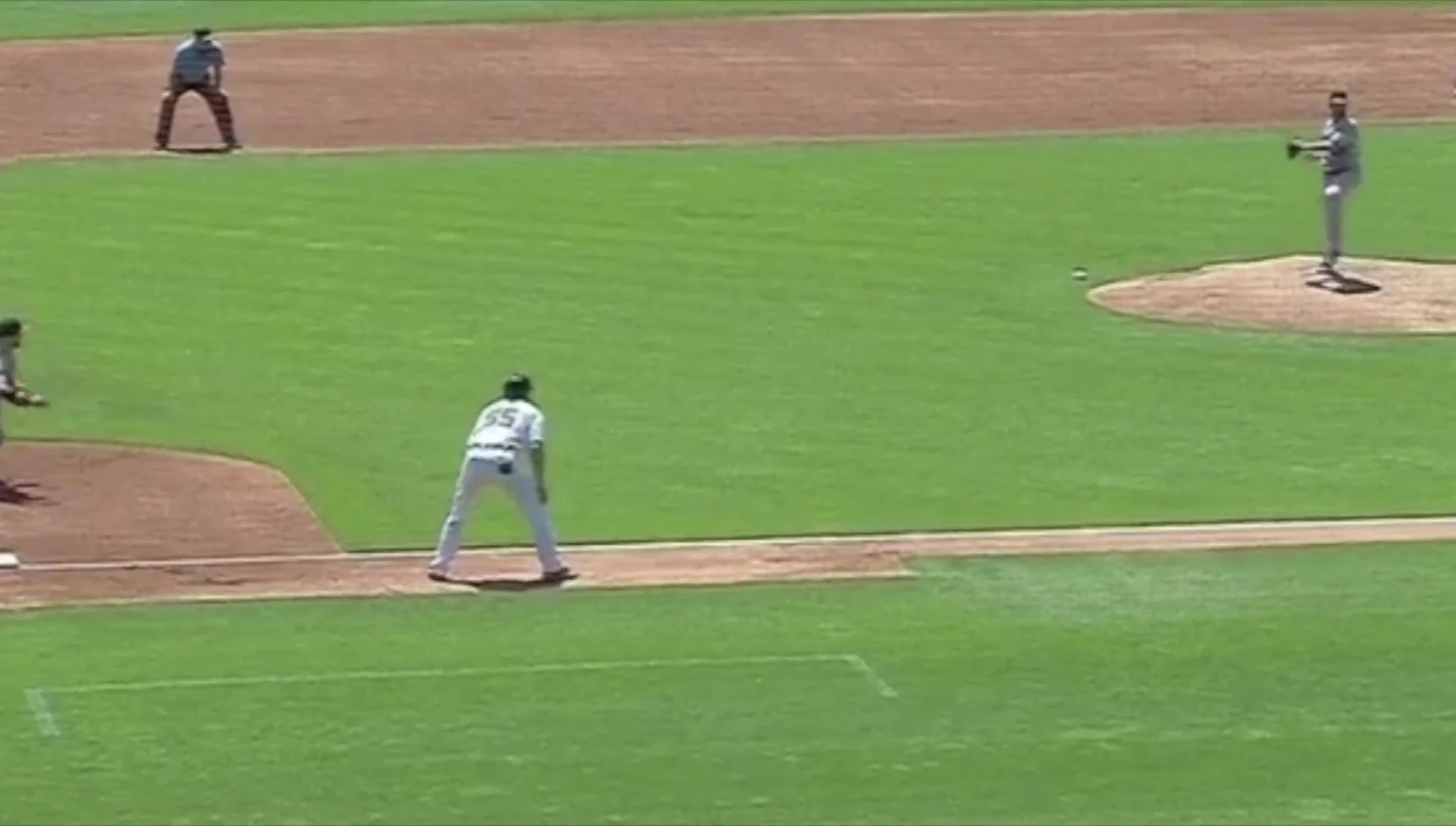 The runner's minimal reaction to the pickoff attempt before he's tagged out.